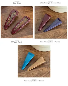 Detailed view of color-blocked acrylic BB hair clips with textured faux stitching on wood