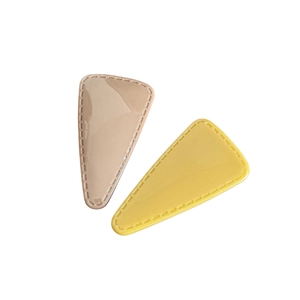 Minimalist beige and yellow triangle BB hair clips with decorative stitching and glossy finish