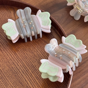 Elegant candy-shaped acetate hair claw with rhinestones and colorful stripes for women