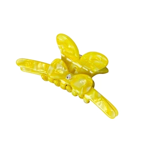 Gelbe Haarspange in Schmetterlingsform aus Acetat mit Marmoroptik und kleinem Strass