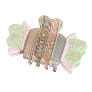 Elegant candy-shaped acetate hair claw with colorful stripes and sparkling rhinestones