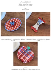Detailed close-up of retro red checkered apple hair clips with bow accents