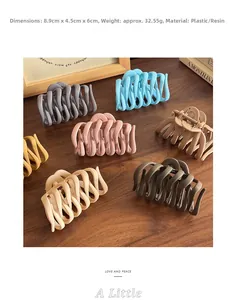 Detailed view of matte pumpkin hair claws in seven colors on a wooden table background