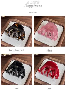 Detail of four acetate hair claws in tortoiseshell and solid colors with gold labels