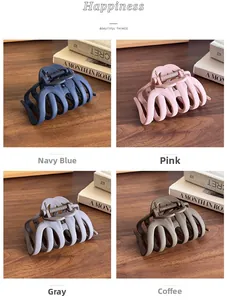 Matte finish shark hair clips in four colors shown on a wooden desk with a warm aesthetic