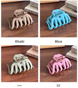 Matte shark hair clips in khaki, blue, green, and rose red shown on a wooden table