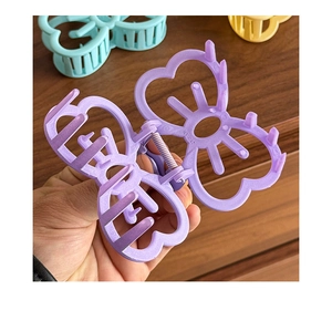Détail de la pince à cheveux lilas montrant la texture mate et le mécanisme du ressort