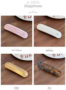 Détail de barrettes en acétate coloré avec gravure dorée France Handmade