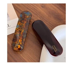 Détail de barrettes en acétate écaille et marron avec marquage doré France Handmade