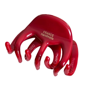 Deep red handmade acetate hair claw clip with golden France label on white background