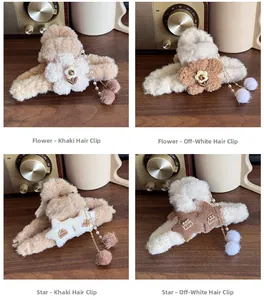 Detailed view of plush claw clips with pearls and fuzzy pom-poms in khaki and cream