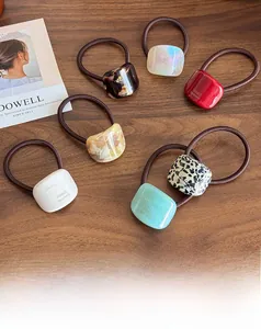 Detail view of acetate geometric hair ties with marble and tortoiseshell patterns