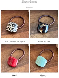 Detail of four acetate geometric hair ties with France Handmade gold engraving on wood