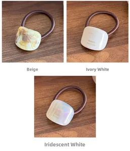 Detailed view of high elasticity hair ties with marble and pearl finish acetate ornaments