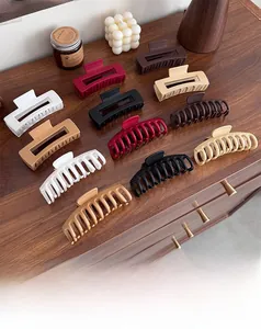 Close-up of 12 matte silicone hair claws in various colors on a wooden surface