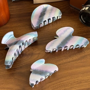 Set of large marble acetate shark hair clips with purple and blue iridescent patterns