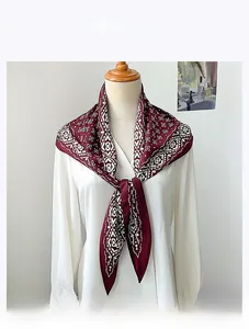 Detail of burgundy vintage geometric pattern scarf in imitation velvet on a white shirt