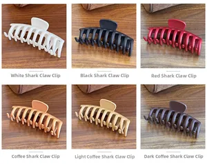 Detail view showing a set of large matte shark hair claw clips in six classic earthy colors