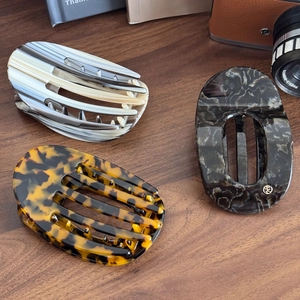 Three-piece large acetate hair claws in tortoise, marble, and grey patterns