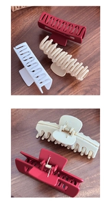 Close-up of soft matte silicone shark hair clips in red, white, and beige colors