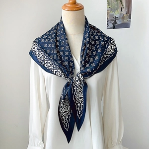 Navy blue bohemian geometric floral scarf styled as a necktie on a white shirt model