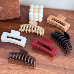 Set of six matte silicone large hair claw clips in various neutral colors for women
