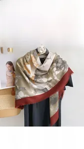Detail of mercerized wool scarf featuring grey marble print and burgundy fringe edges