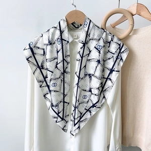 Elegant geometric print silk scarf with double ring patterns on a white shirt
