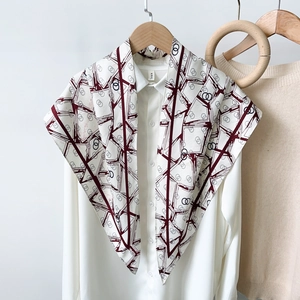 Abstract geometric printed silk scarf with burgundy lines on white shirt