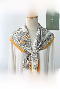 Detail of Korean-style printed silk scarf with black and white plant texture and yellow trim