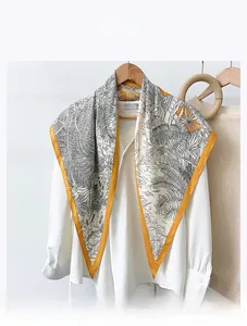 Detailed macro view of high-quality imitation velvet silk scarf with leaf prints