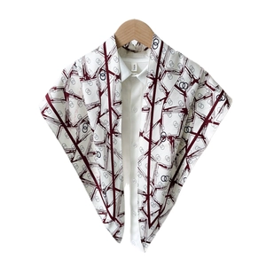 Elegant geometric silk scarf with red and black stripes over a white shirt