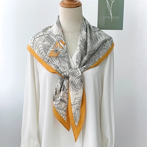 Elegant tropical leaf print silk scarf in black and white with a mustard yellow border