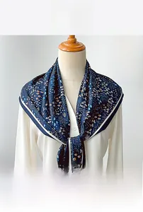 Detail of navy blue floral triangle scarf with delicate patterns on lightweight fabric