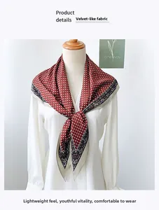 Detail of red-brown geometric silk scarf with ethnic pattern on a white shirt