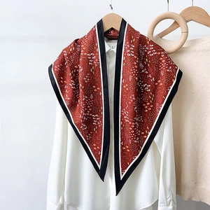 Elegant floral silk-feel triangle scarf in red and black, tied on a white shirt