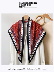 Detailed view of denim blue silk-like fabric scarf with retro geometric patterns