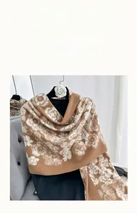Close-up of brown floral winter scarf showing thick cashmere-like soft fabric texture