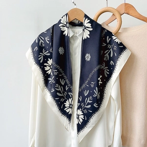 Elegant navy blue floral silk triangle scarf with daisy print on white shirt