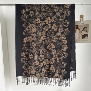 Detail of vintage camellia floral pattern and fringe hem on a warm winter shawl