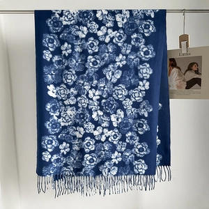 Detailed view of soft navy floral cashmere-feel scarf with elegant fringed edges