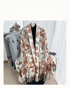 Dettaglio di sciarpa floreale in finto cashmere con trama spessa e nappe a frangia
