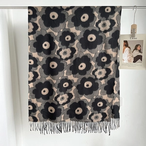 Detailed view of black and grey floral poppy print scarf with delicate fringed edges