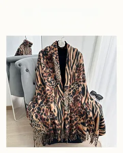 Close-up of leopard print scarf with fine fringe detailing on a camellia flower hanger