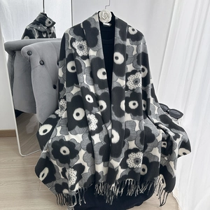 Detail of black and white floral print scarf with thick fabric and fringe tassels