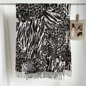 Detailed view of the leopard print scarf with striped splicing and soft fringe edges