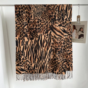 Close-up of leopard and zebra print scarf with tassels made of soft cashmere-like fabric