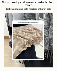 Close-up of premium cashmere-like scarf fabric with geometric pattern and tassel fringe