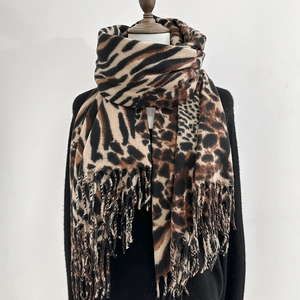 Winter leopard and zebra print scarf in warm faux cashmere with fringe on a mannequin