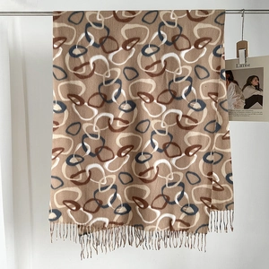 Close-up of geometric circle pattern scarf with soft long fringe and earthy tones